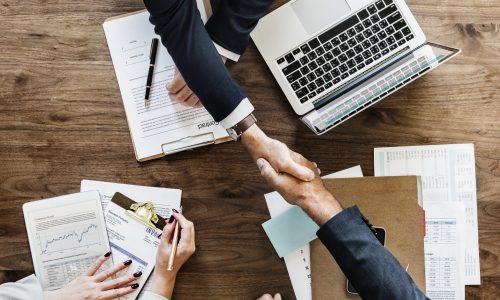 Business people shaking hands together